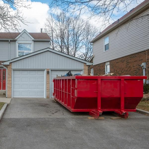 open-top construction dumpster loaded with construction waste